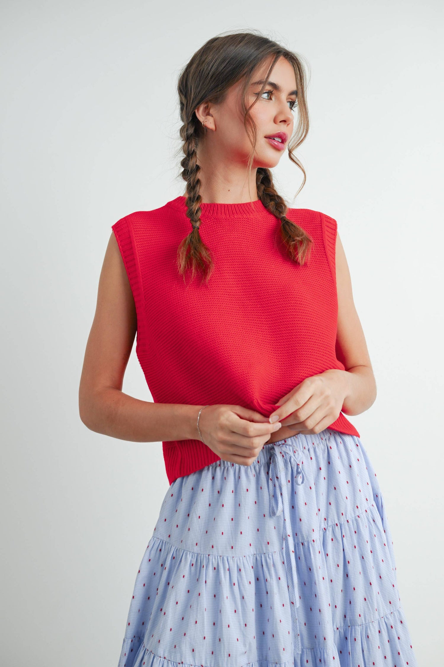 red sleeveless sweater and Blue skirt with red dots