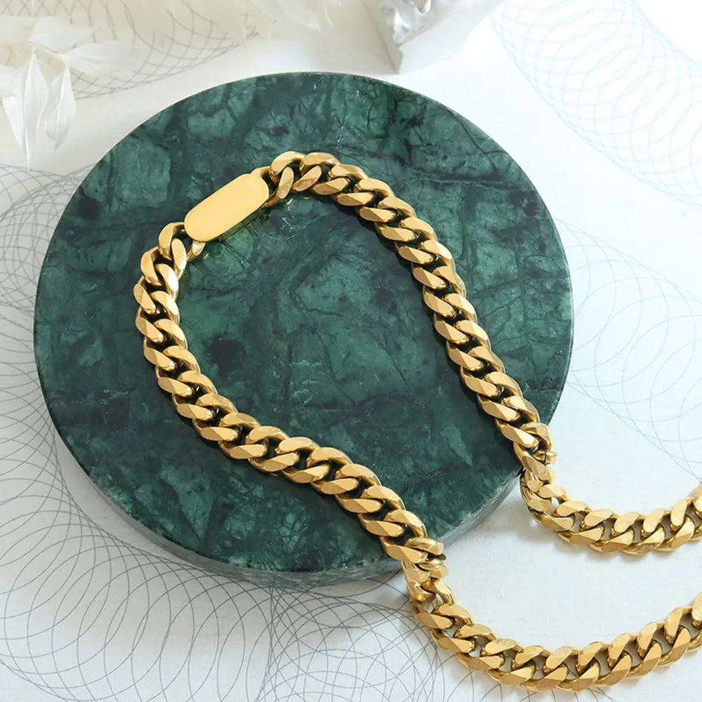 gold chain on a green jewelry pillow